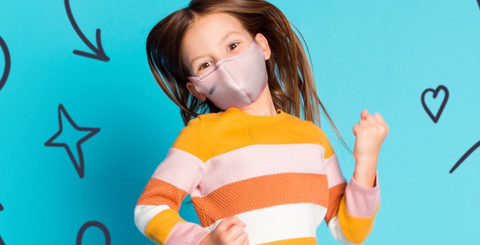 a girl wearing a mask jumping